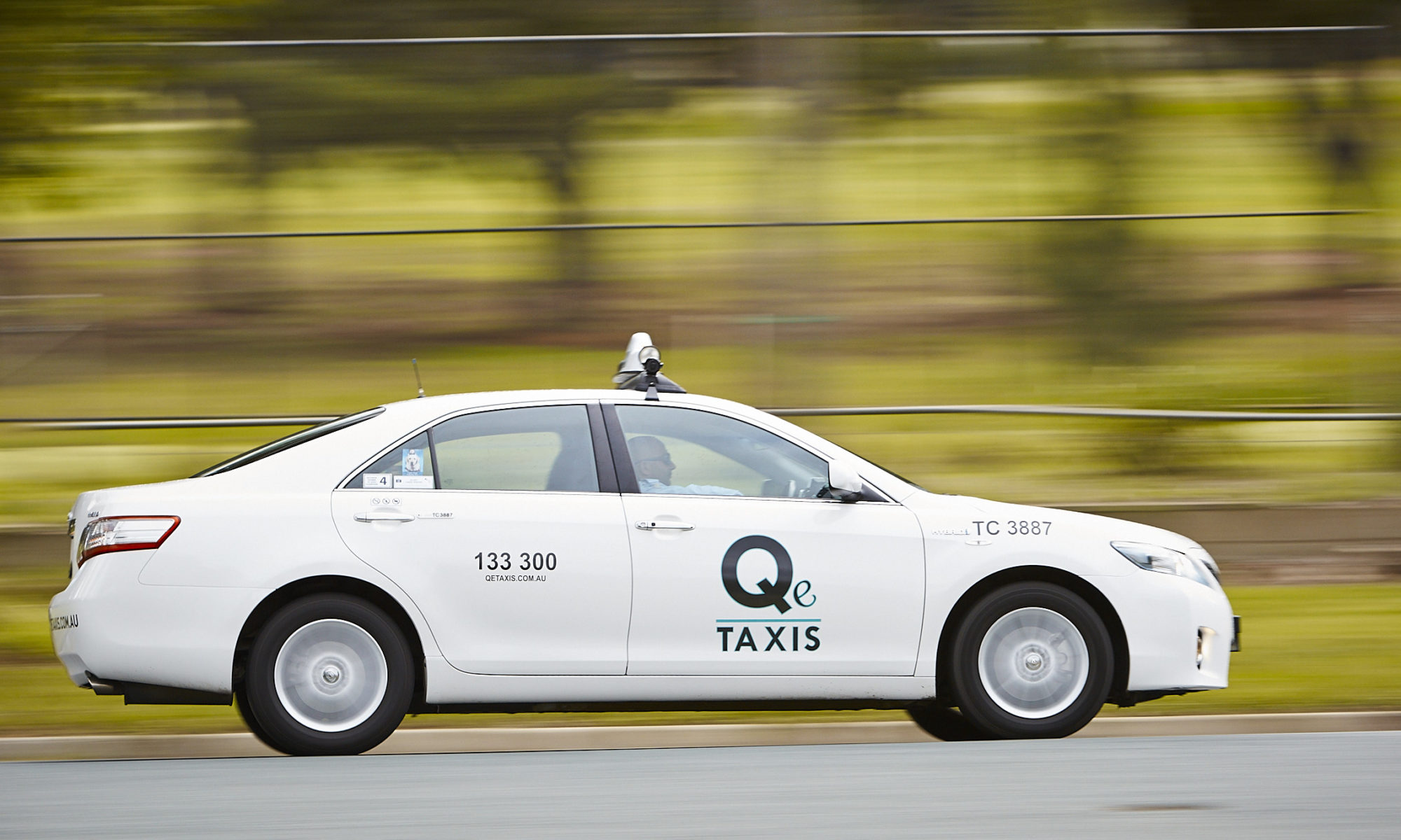 Q e Taxis driving through Queanbeyan
